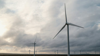 Wind turbines under the grey sky